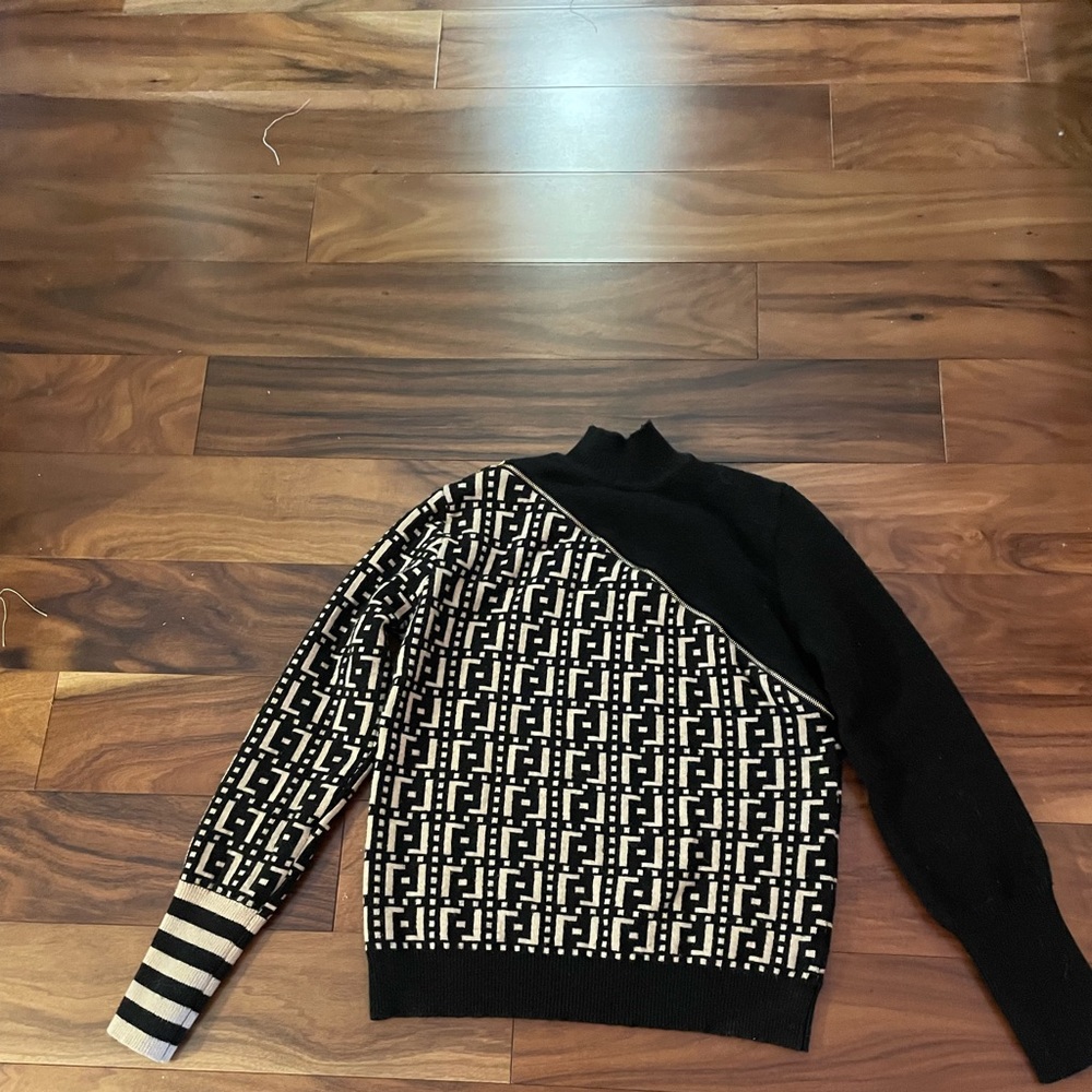 Size S sweater. Never worn! Black and gold with front decorative zipper.